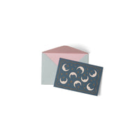 Card with moon designs and a matching envelope on a white background